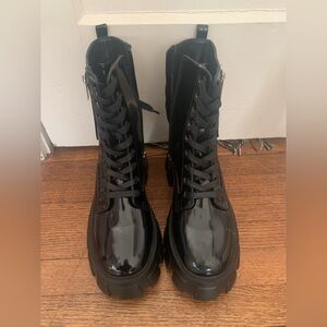 Brand New Black platform boots with 4 inch heel.